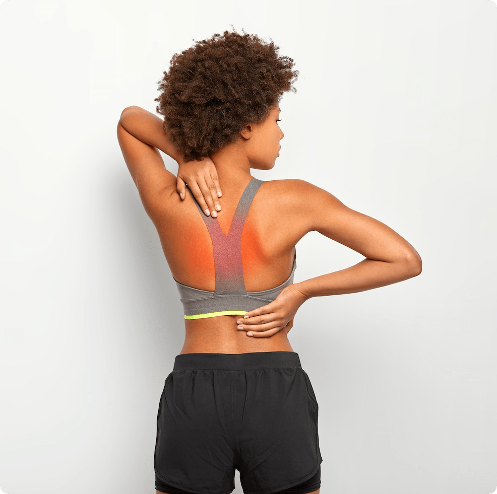 slim-woman-has-cronic-painful-feelings-back-poses-against-white-background-has-injury-cramps-wears-grey-top-shorts-rounded-2